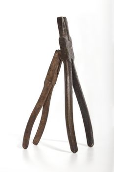 pair of old rusty pliers in collaboration vertically
