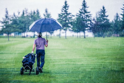 Golfer on a Rainy Day Leaving the Golf Course (the game is annulled because of the storm)