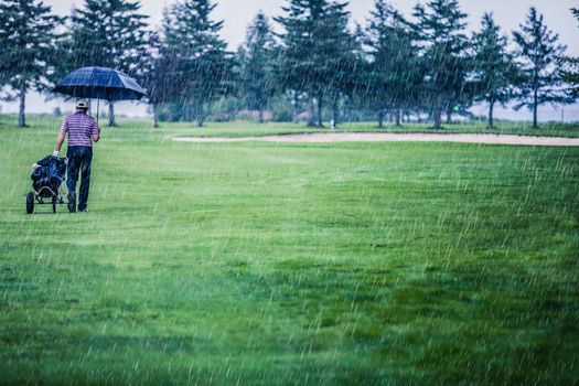 Golfer on a Rainy Day Leaving the Golf Course (the game is annulled because of the storm)