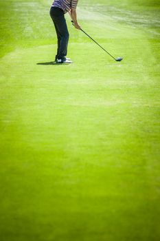 Golfer on a Golf Course on the Start with lot of Copyspace for your text (preparation)