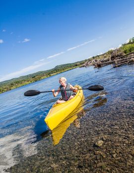 Calm River and Woman Kayaking in Gaspe, Quebec, Canada