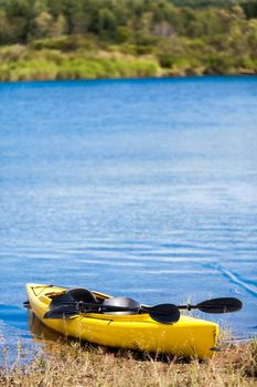 Yellow Kayak Ready to be Used on the Cost of a River