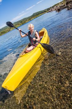 Calm River and Woman Kayaking in Gaspe, Quebec, Canada