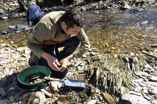 Gold digger in France in the river Tarnon the heart of the Cevennes in the department of Lozere