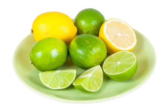 Lemon and lime fruits on a plate isolated on white background with clipping path