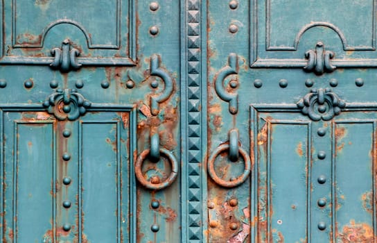 Ornate rusty iron gate close detail.