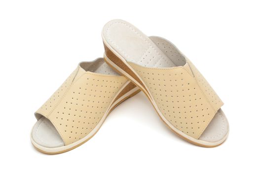 beige female shoes on a white background