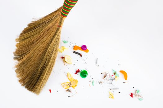 a new broom sweeping various debris and mud