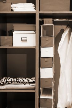 Clothes and towels in a wooden wardrobe