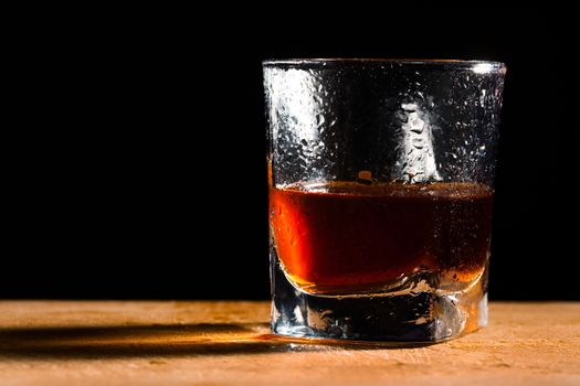 glass from whisky on a wooden table