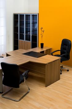 large wooden desk in a modern office