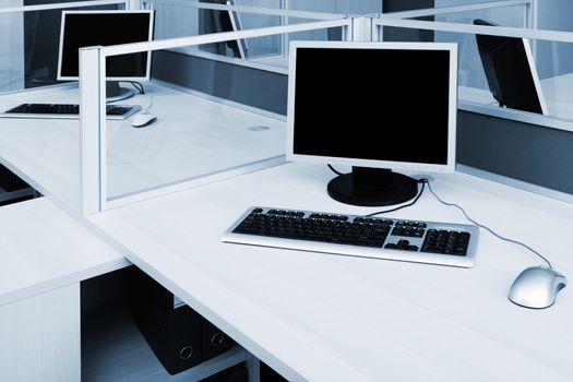 computers behind the glass in a modern office