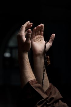 Hands Holding A Muslim Rosary In Mosque