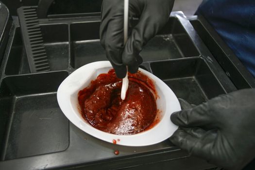 Hairdresser preparing bowl with peroxide for hair dyeing treatment, closeup