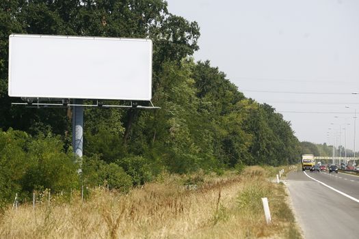 Empty billboard on background of sunset sky for your advertisement