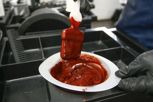 Hairdresser preparing bowl with peroxide for hair dyeing treatment, closeup