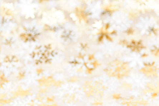 Golden abstract blurred Christmas background with snowflakes