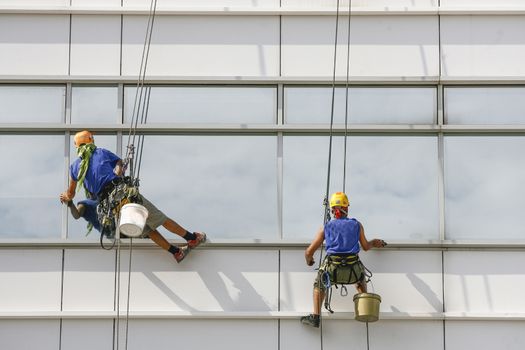 Two window cleaners in the building