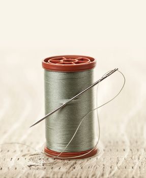 Spool of thread with needle for sewing