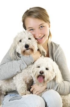 Pretty teenage girl holding two adorable coton de tulear dogs