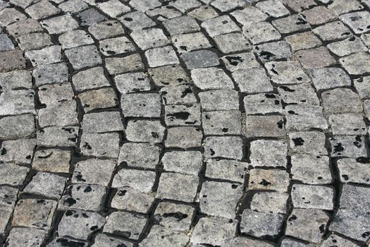 small cobblestone sidewalk made of cubic stones structured background