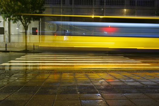 Long exposure in night traffic on road and pedestrian crossing
