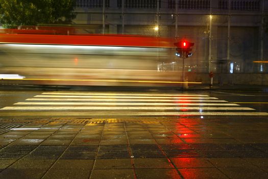 Long exposure in night traffic on road and pedestrian crossing
