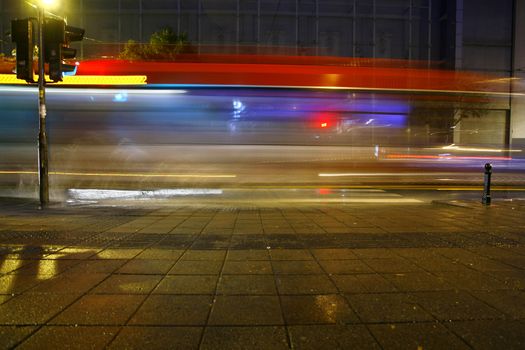 Long exposure in night traffic on road and pedestrian crossing
