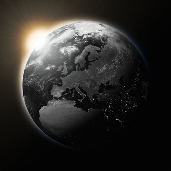 Sun over Europe on dark planet Earth isolated on black background. Highly detailed planet surface. Elements of this image furnished by NASA.