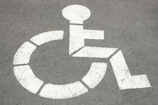 white sign for handicapped who indicates parking space