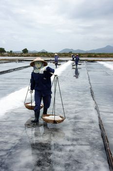 BA RIA, VIET NAM- FEBRUARY 3: Salt worker working on salina,they harvesting white salt in  Ba Ria, VietNam on February 4, 2013