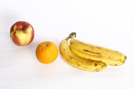 Fresh ripe bananas bunch and orange  apple isolated on white background