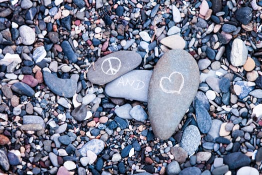 Peace and Love symbols on rocks in nature