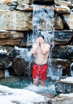 Courageous Man under Nordic Cold Water Spa Cascade