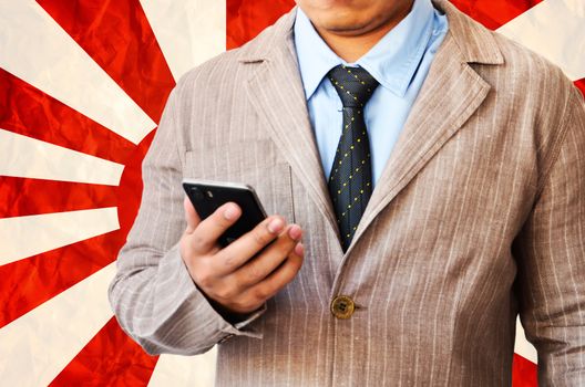 Business man working with phone on  on Japanese navy flag  background