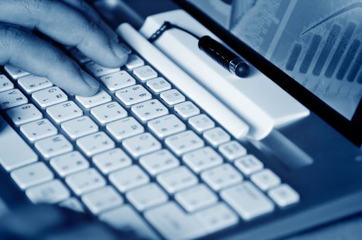 Male hands typing on computer keyboard