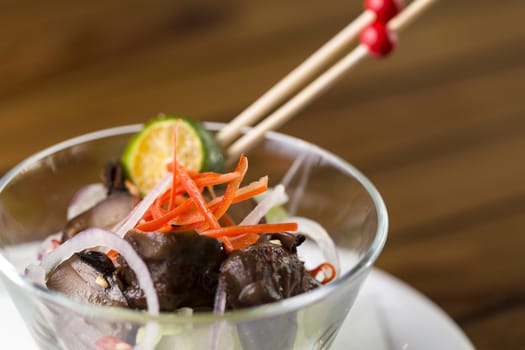 A close up of a glass of mushroom appetizer to be served.