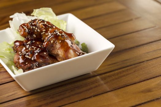 Barbecue buffalo wings with sesame sauce ready to be served.