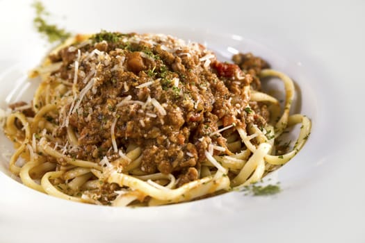 A plate of Spaghetti bolognese isolated on white.