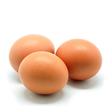 Three of brown chicken egg isolated on a white background