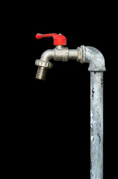 faucet with red handles on black background