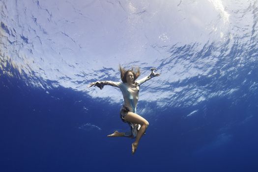 girl giving hand to you underwater