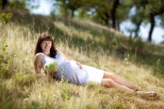 young fashion pregnant girl in a long dress