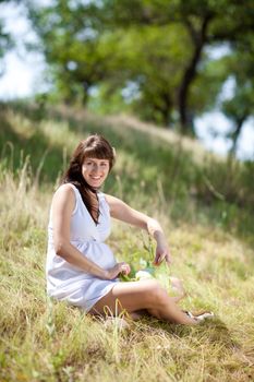 young fashion pregnant girl in a long dress