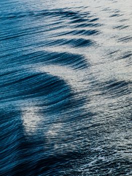 Blue water waves behind ship