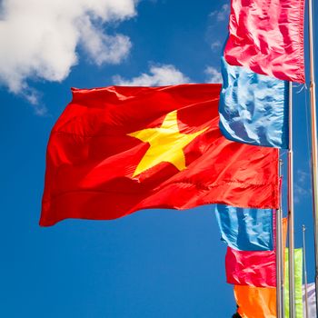 Vietnamese flag waving in the wind against blue sky
