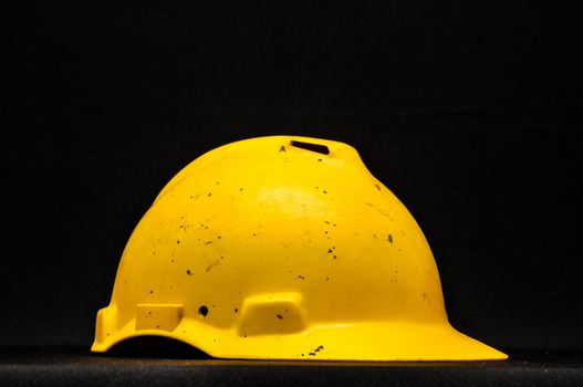 Yellow Safety Helmet on a Black Background