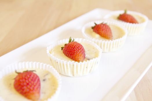 Chese cake with Strawberry on top on wood background