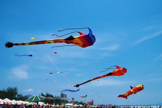 Flying kite in the air against blue sky