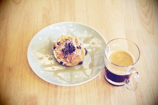 Black coffee with dessert on wood 